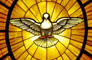 A dove, symbolizing the Holy Spirit, who is be...