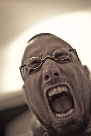 Man's face screaming/shouting. Stubbly wearing... Man's face screaming/shouting. Stubbly wearing...