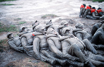 Image of BUD/S trainees covered in mud during ...